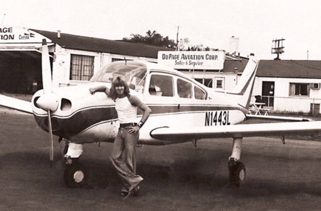 Gregg Owen standing beside a small plane at DuPage Aviation
